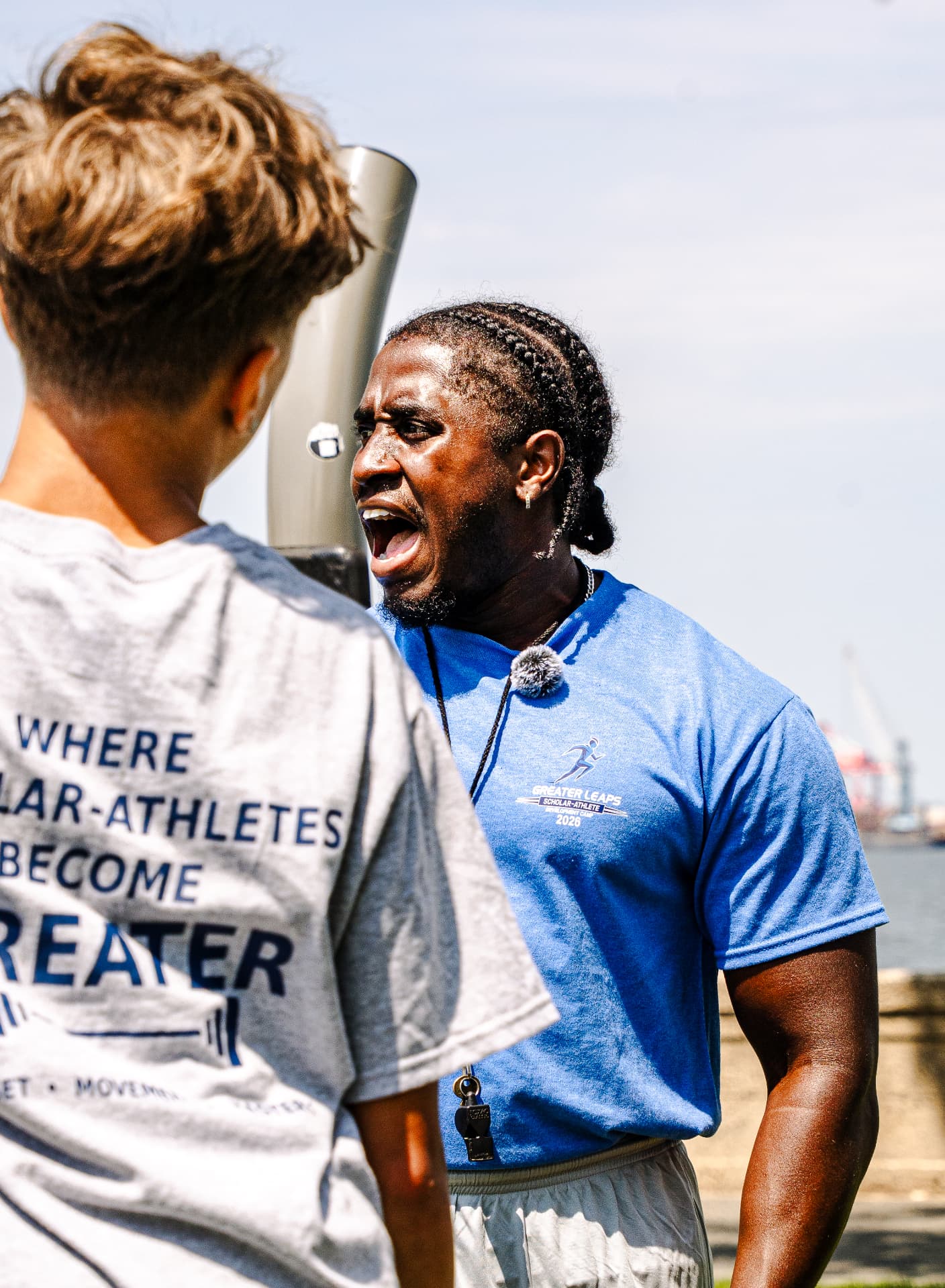 Coach giving a cue to a scholar-athlete at the waterfront