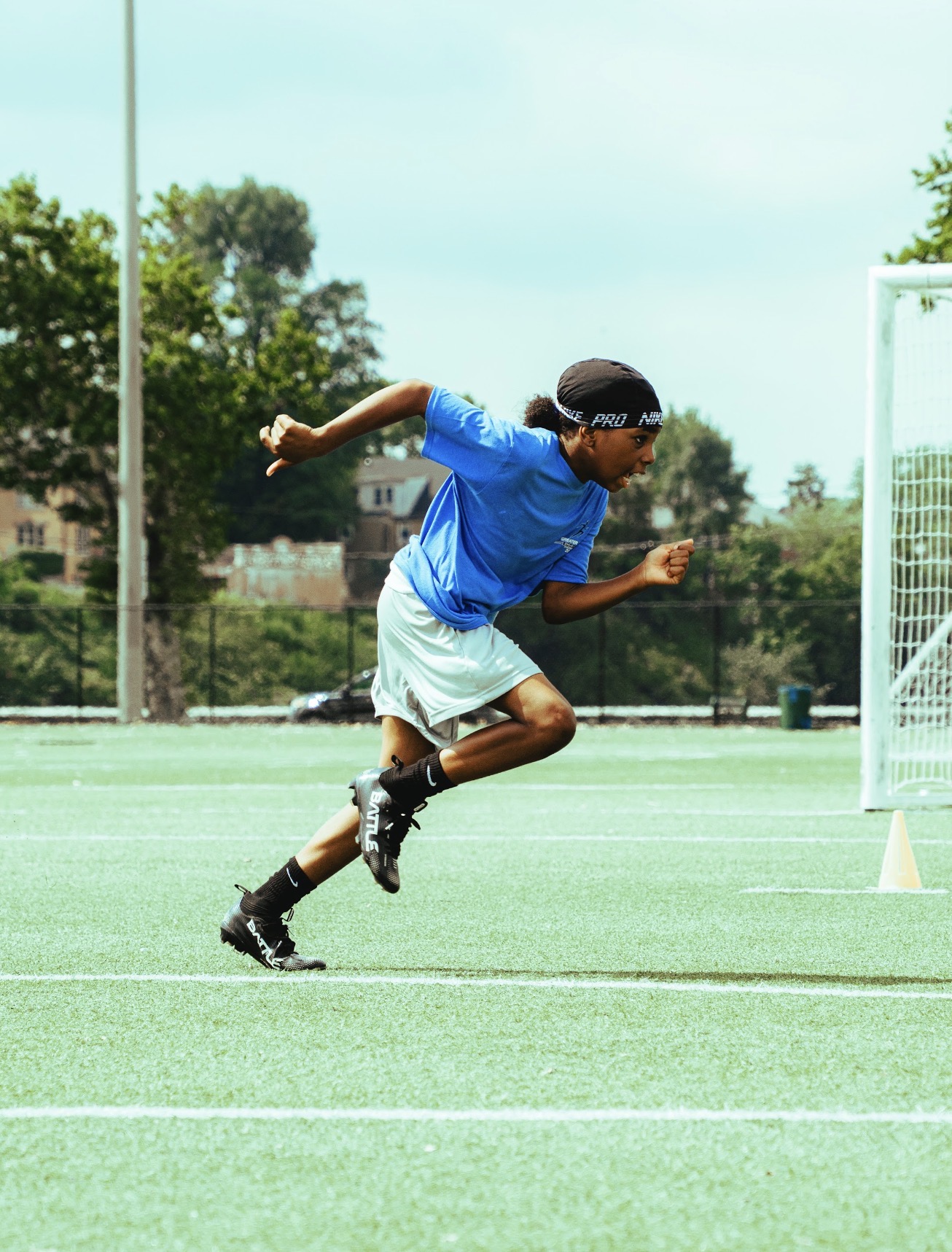 Scholar-athlete exploding out of a sprint start on the turf